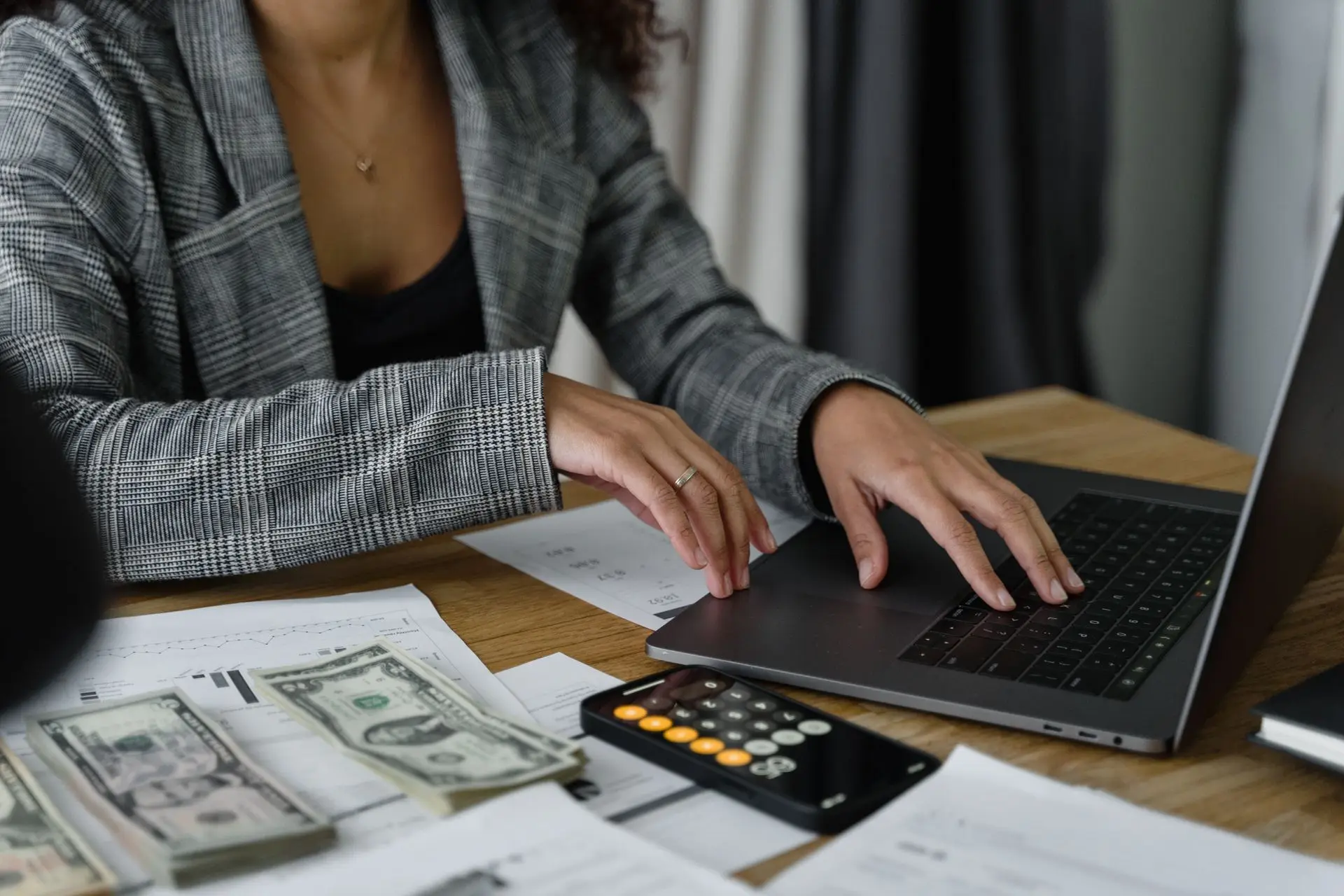 Financial analyst reviewing reports at a desk