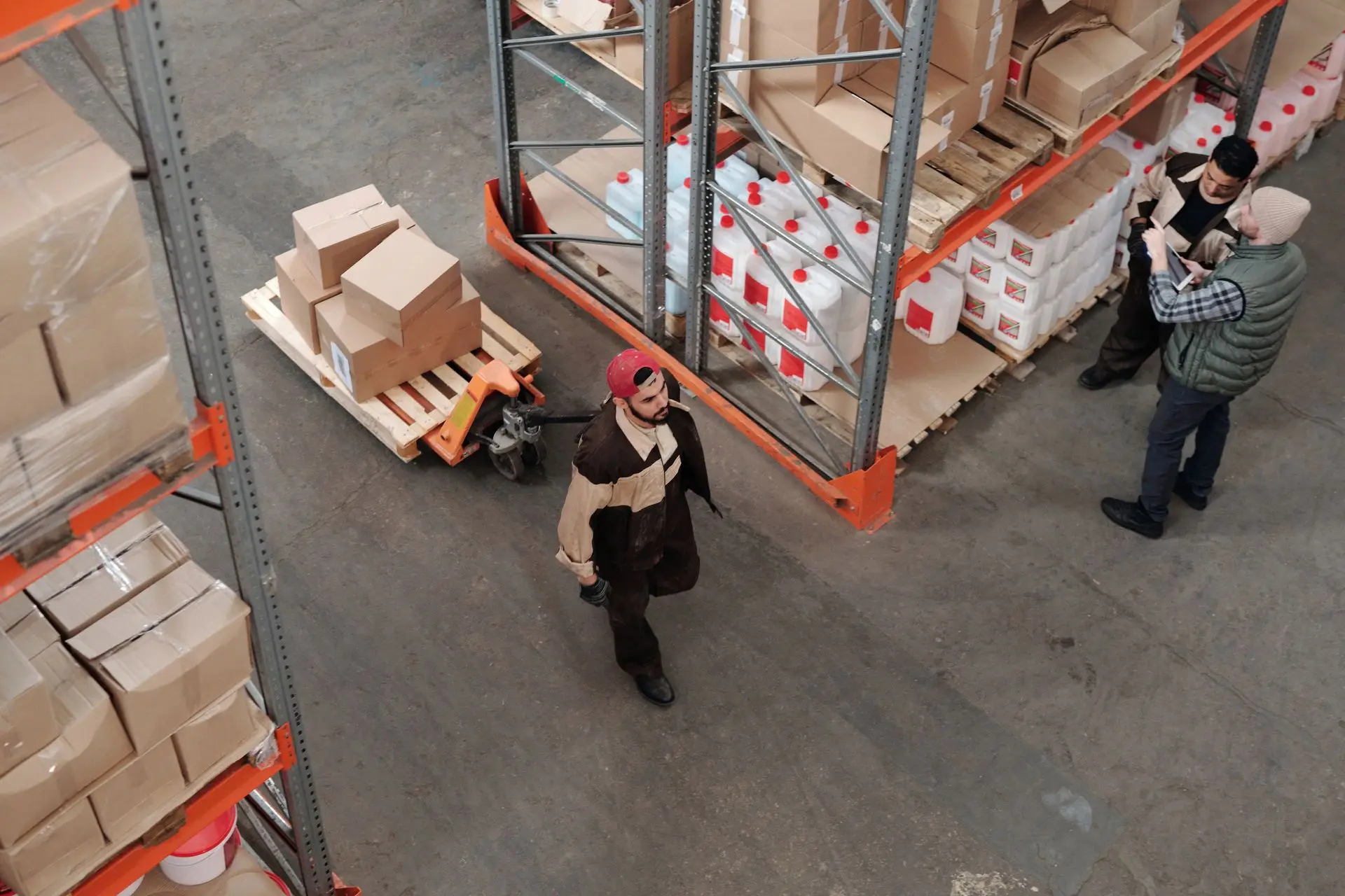 Warehouse aisle stacked with goods on industrial racks